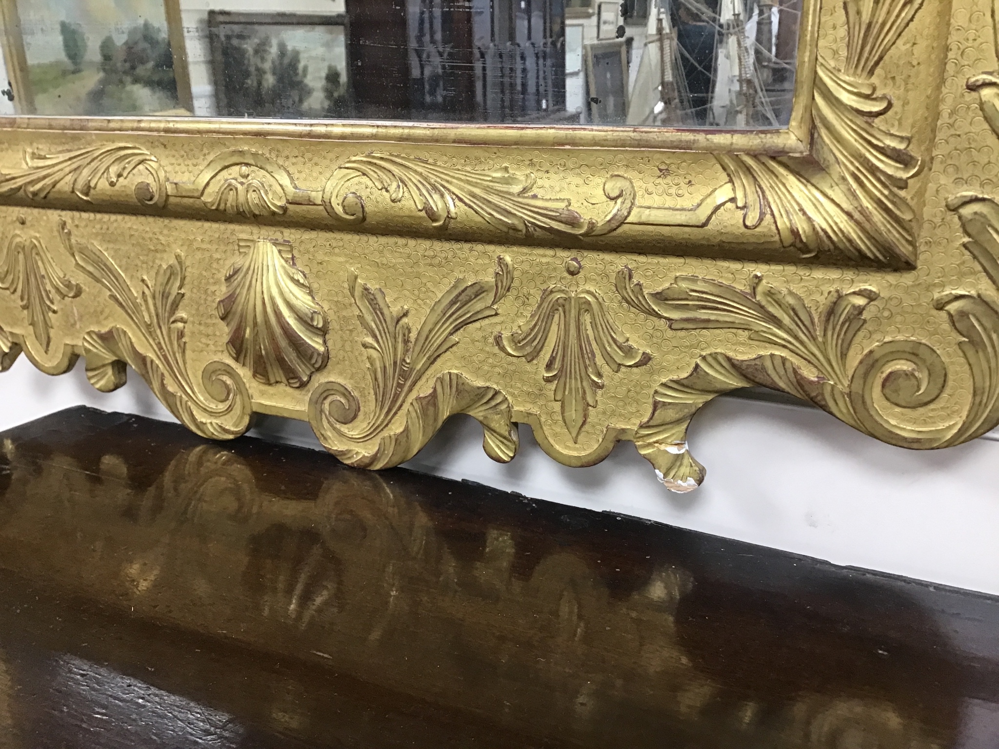 A pair of George II style carved giltwood wall mirrors, with scroll pediments, width 58cm, height 106cm